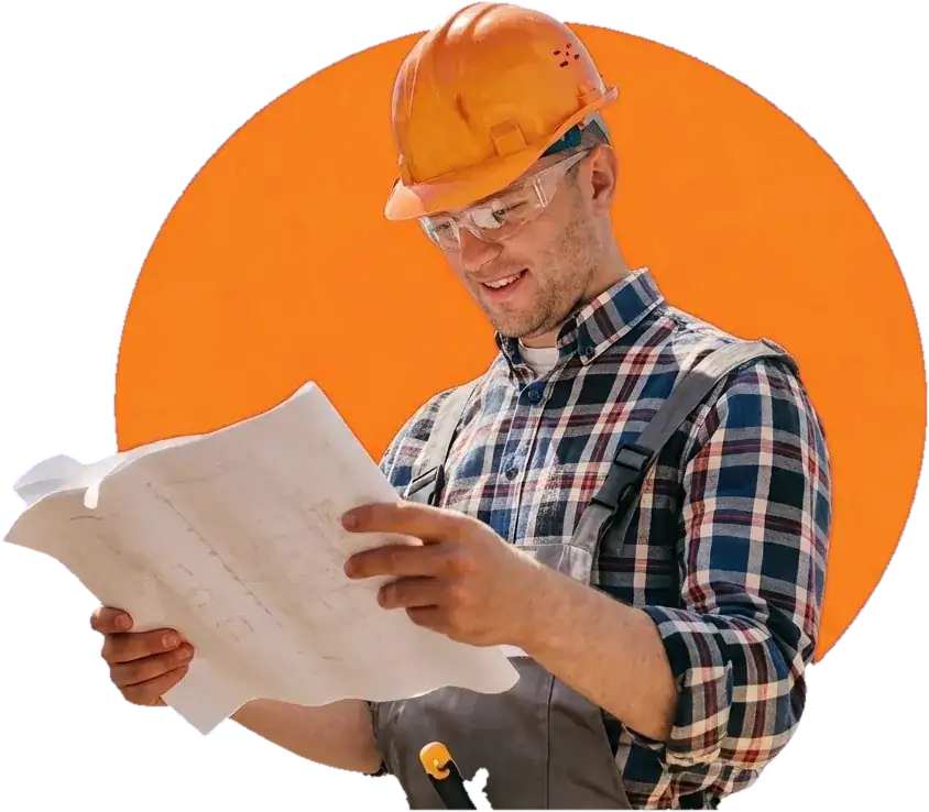 Tradesperson in a hard hat reading renovation plans